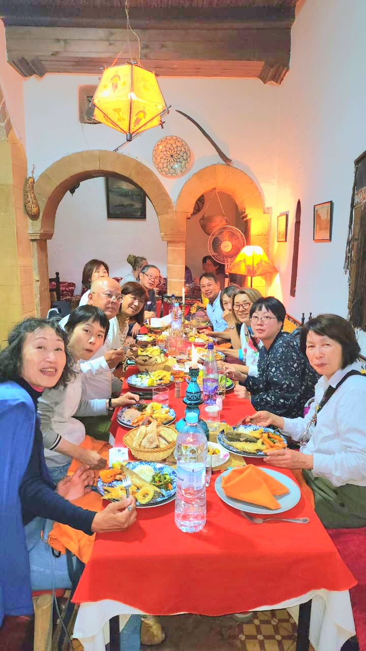 Group of guests dining together at a Moroccan table